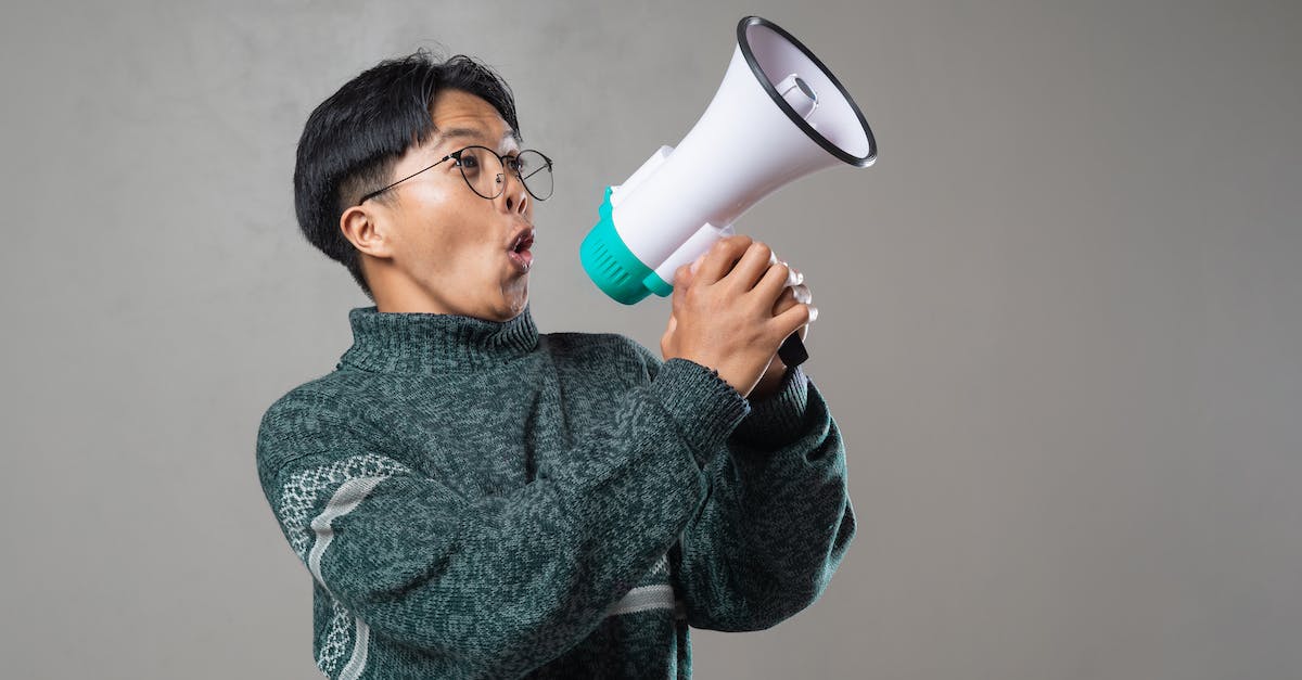 What are the people talking about? - Woman in Gray Sweater Drinking from White Ceramic Mug What are the people talking about? - Woman in Gray Sweater Drinking from White Ceramic Mug