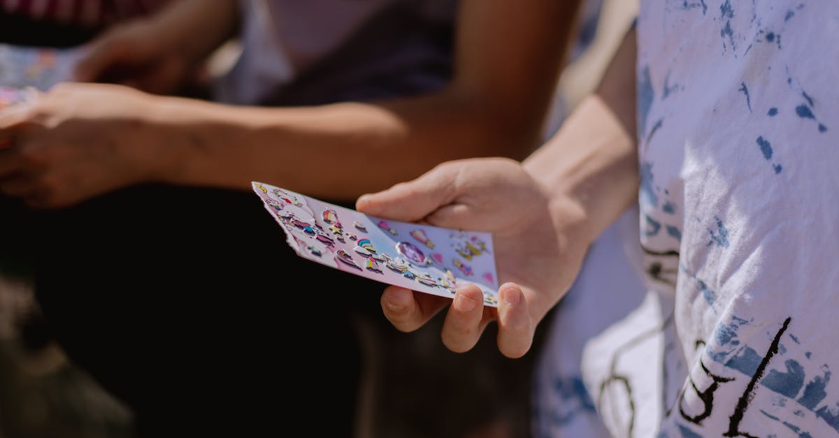 What are the quickest stickers to unlock in Rare Replay? - Person Holding White and Pink Floral Playing Cards