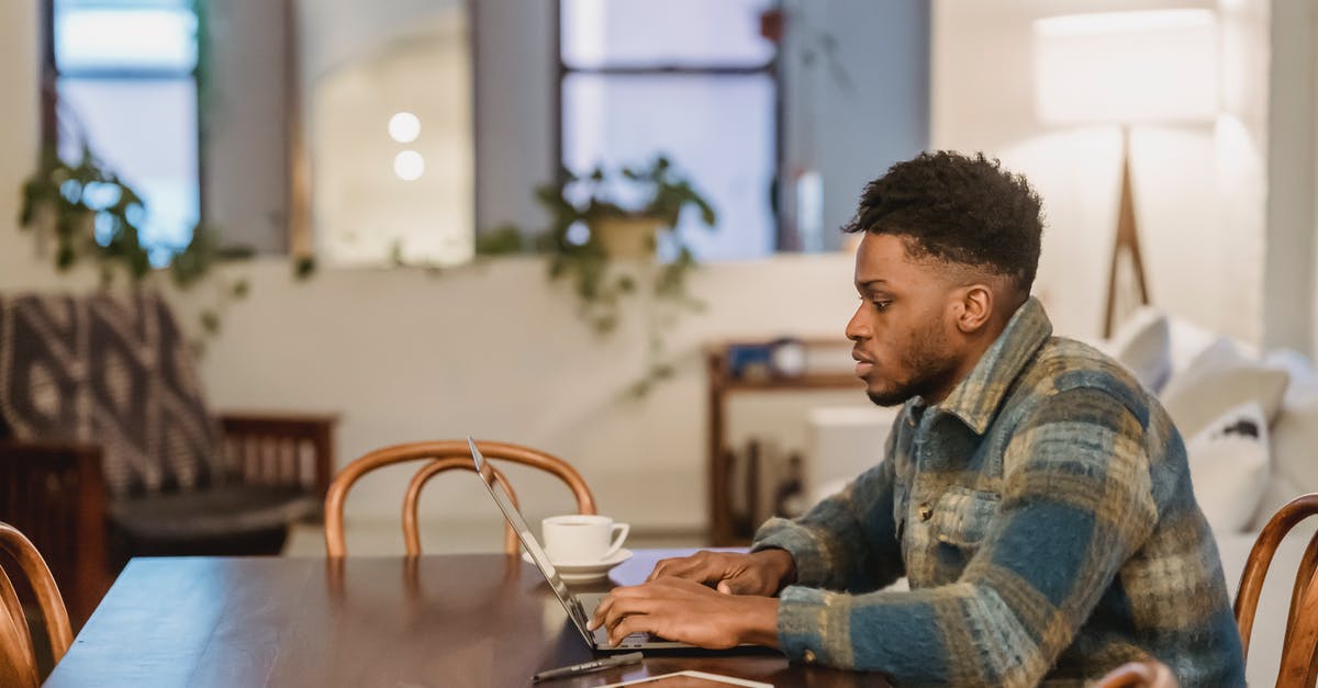 What are the type of view projections in League of Legend, or Dota 2? - Concentrated black man working on laptop at home office