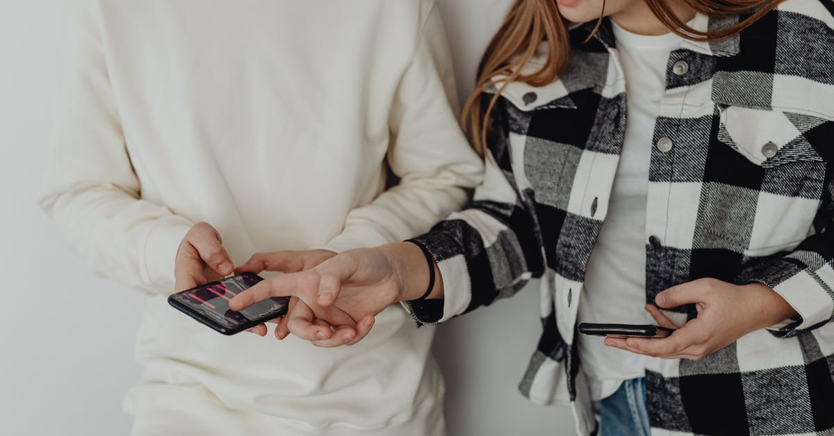 What are the x, y, and z in the /testforblocks command? - Young Couple Looking at Their Smart Phones 