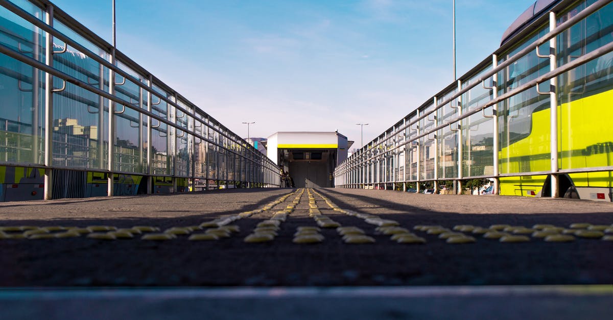 What are these weird 1 wide vertical tunnels? - Ground level of yellow dots on wide empty pedestrian bridge near highway with vehicle