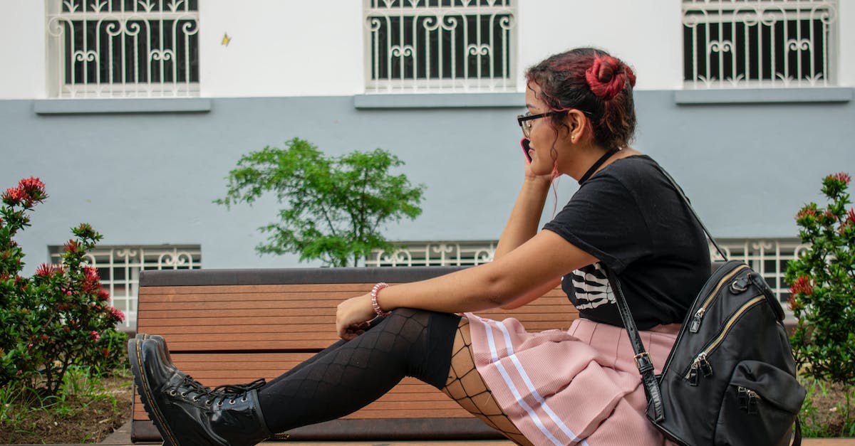 What backpack skin is this? - Woman Sitting on Brown Bench What backpack skin is this? - Woman Sitting on Brown Bench