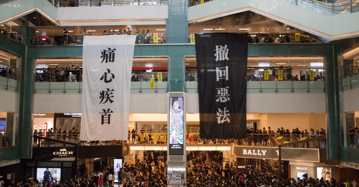 What causes the 006-0612 error and how can I prevent it? - Shopping centre with hanging protestant banners crowded with people on meeting What causes the 006-0612 error and how can I prevent it? - Shopping centre with hanging protestant banners crowded with people on meeting