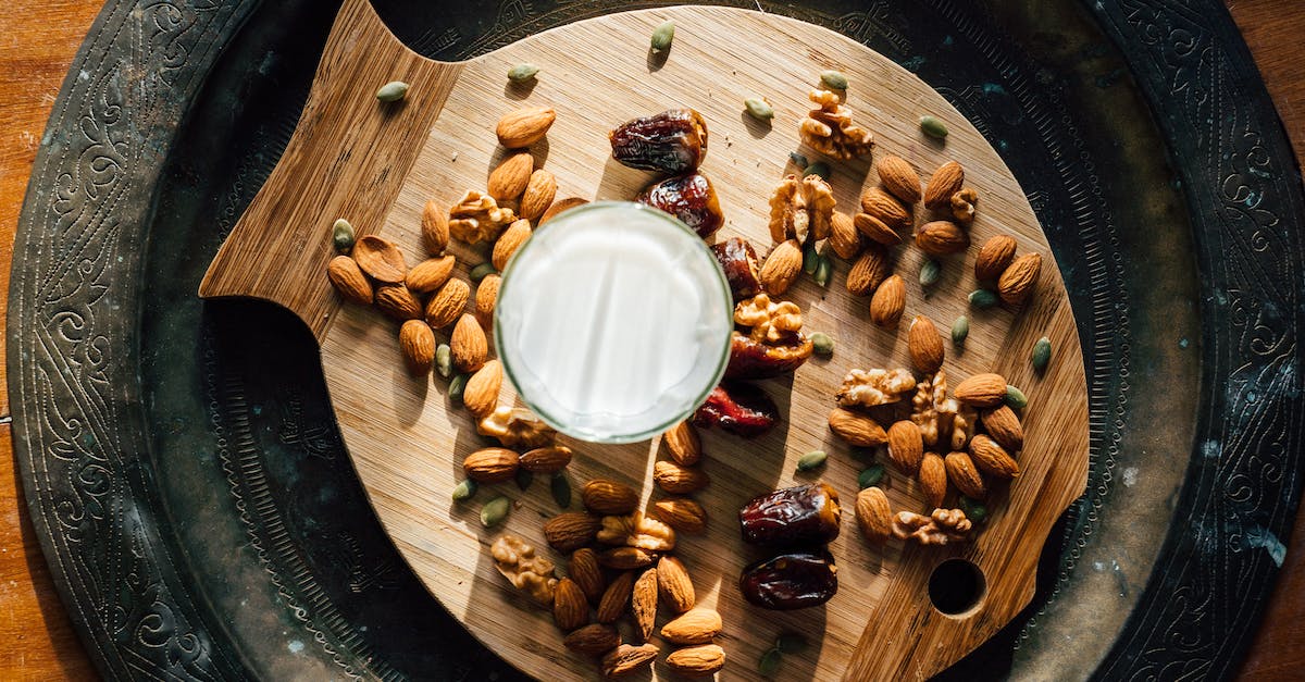 What causes the milk percentage to rise? - Brown and White Nuts on Brown Wooden Round Plate