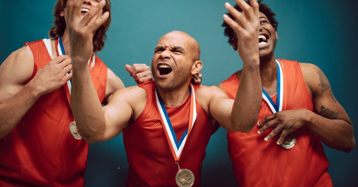 What champions scale the best in League of Legends - Overjoyed Men in Red Jerseys Wearing Their Medals