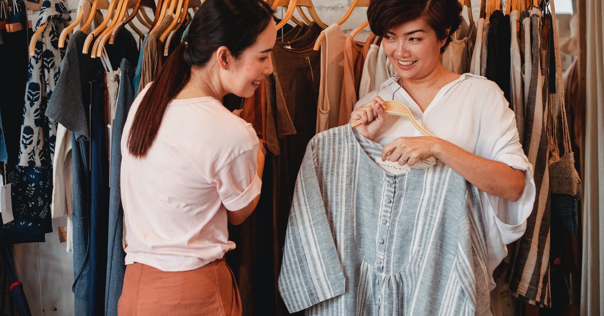 What clothing can my colonists wear together? - Glad Asian shoppers choosing apparel in clothing store What clothing can my colonists wear together? - Glad Asian shoppers choosing apparel in clothing store
