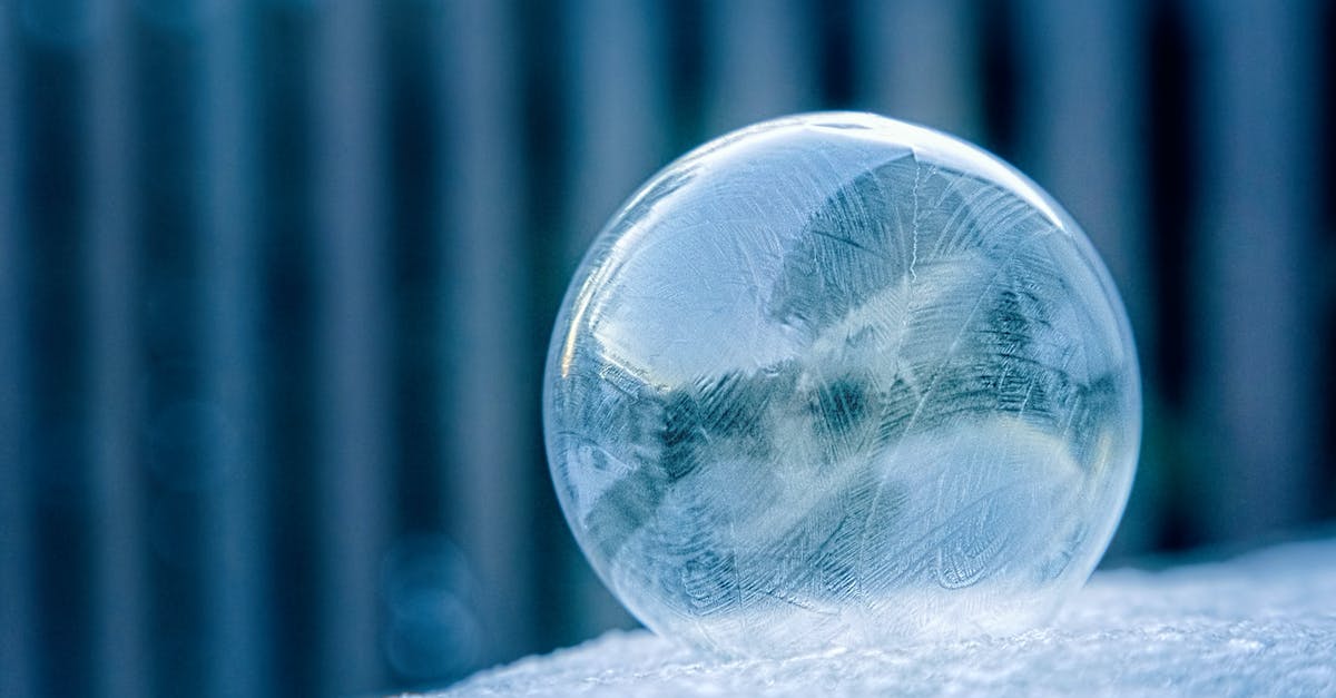 What colour is the ball? - Glass Ball on White Surface