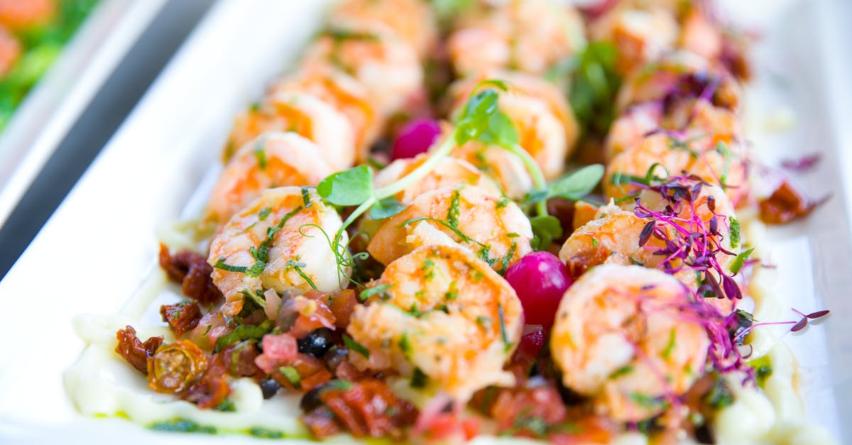 What conditions cause a party to naturally occur? - Closeup of delicious shrimps with vegetables and microgreens on white plate on catering table