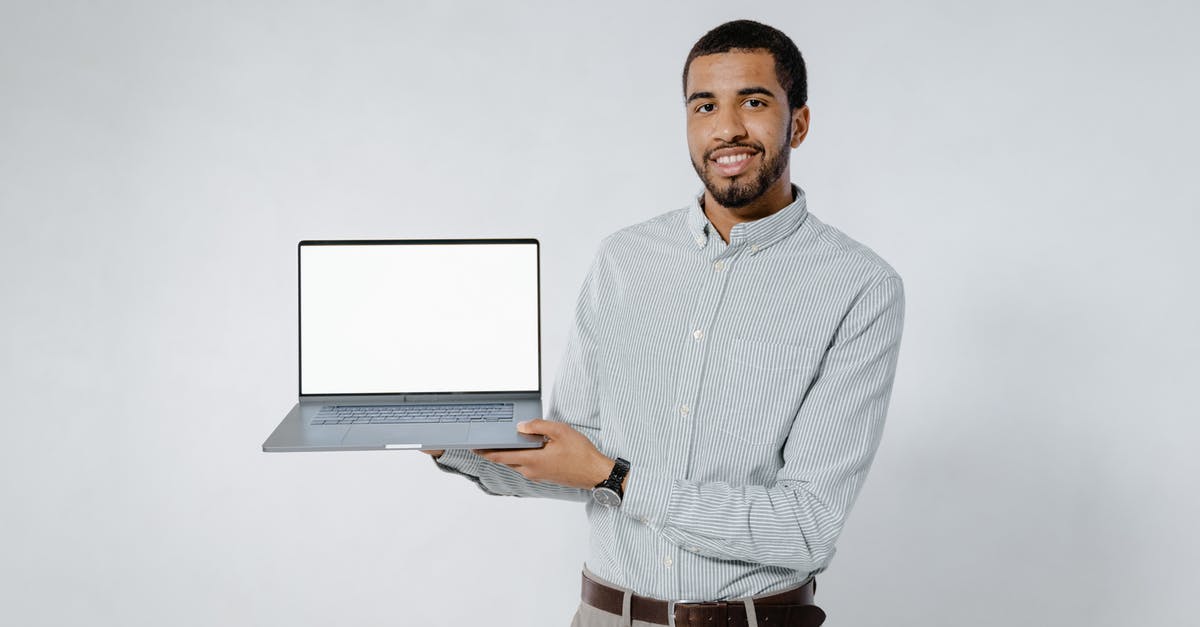 What constitutes as an empty space? - Man in White and Black Striped Dress Shirt Holding Gray Laptop Computer