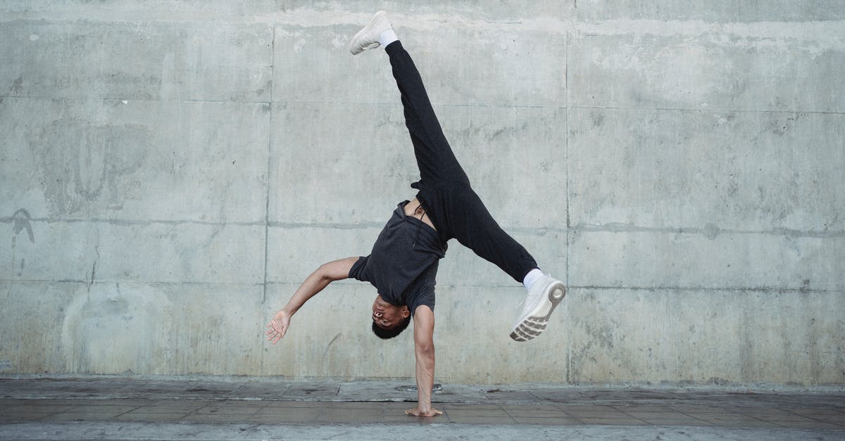 What could cause power to go down just by moving? - Strong man breakdancing on sidewalk of city What could cause power to go down just by moving? - Strong man breakdancing on sidewalk of city