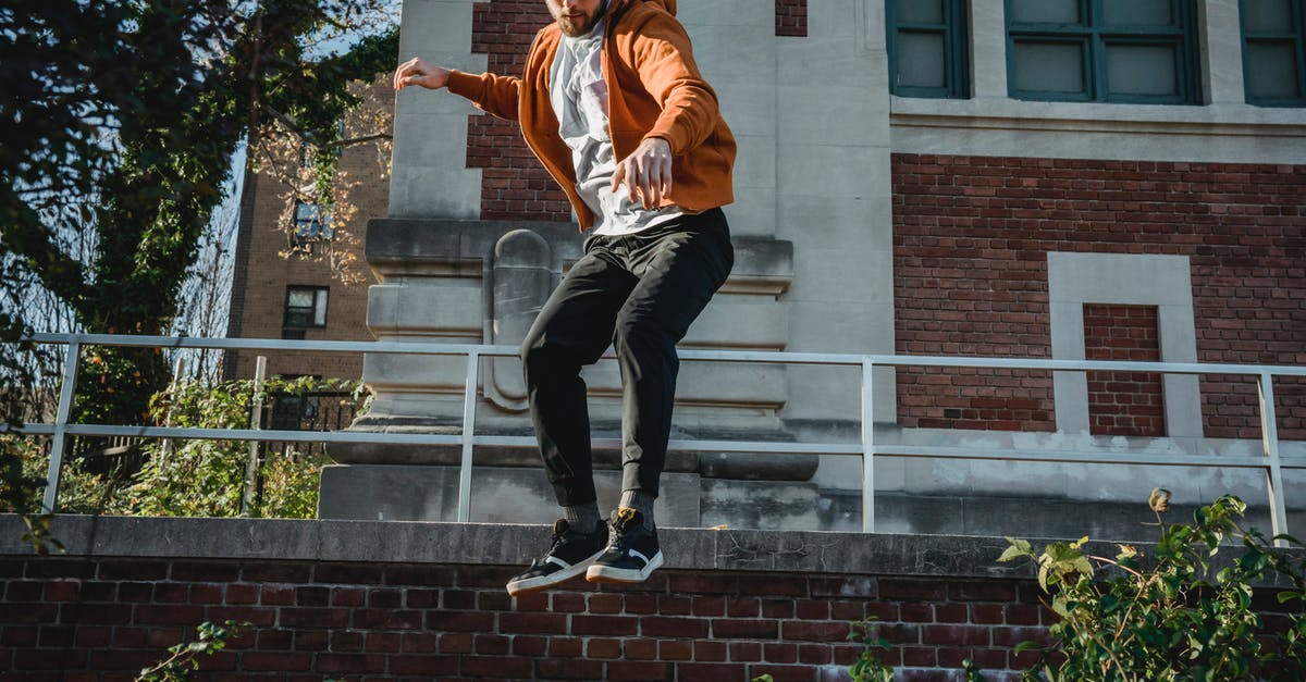 What could cause power to go down just by moving? - From below full body of active male jumping above ground with hands outstretched during parkour practice What could cause power to go down just by moving? - From below full body of active male jumping above ground with hands outstretched during parkour practice