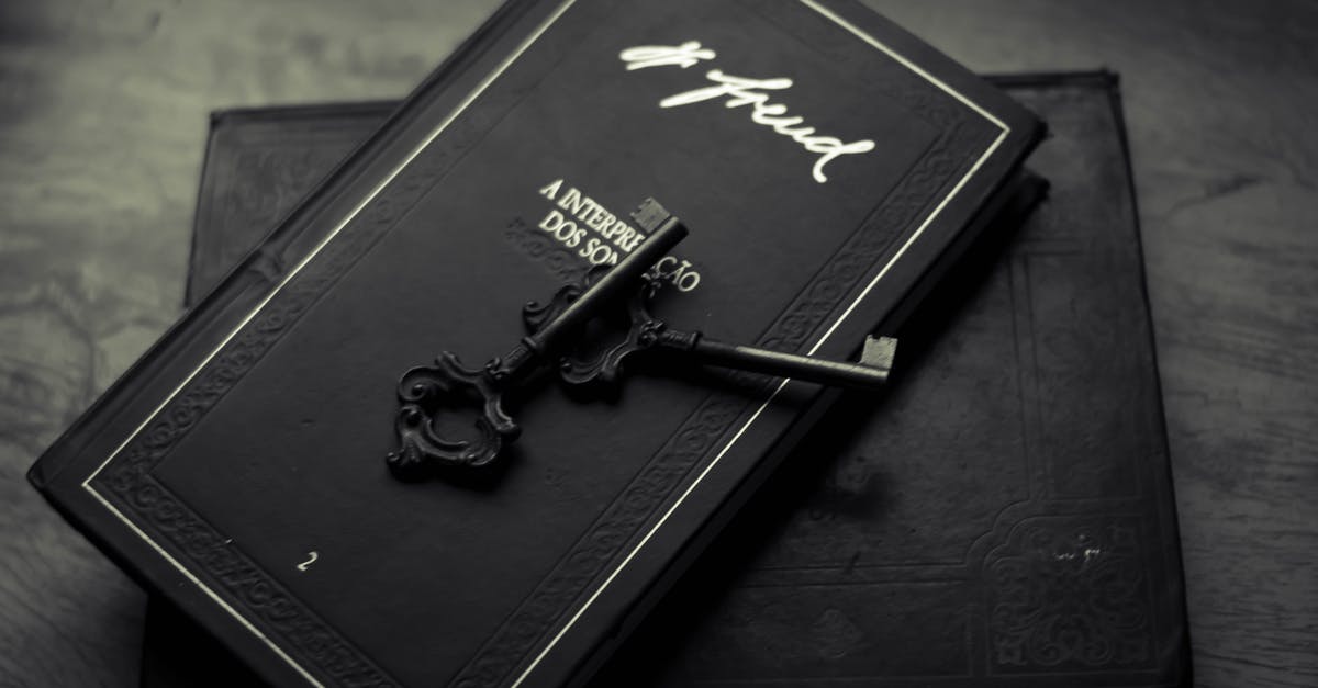 What could stop an old steam key from working? - From above of classic metal key placed on black books on wooden table