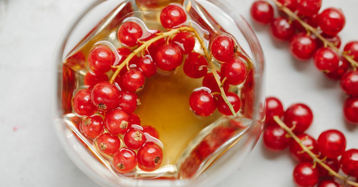 What counts as strong alcohol for potion refilling? - From above of strong aromatic alcoholic drink served with fresh red currant placed on white table