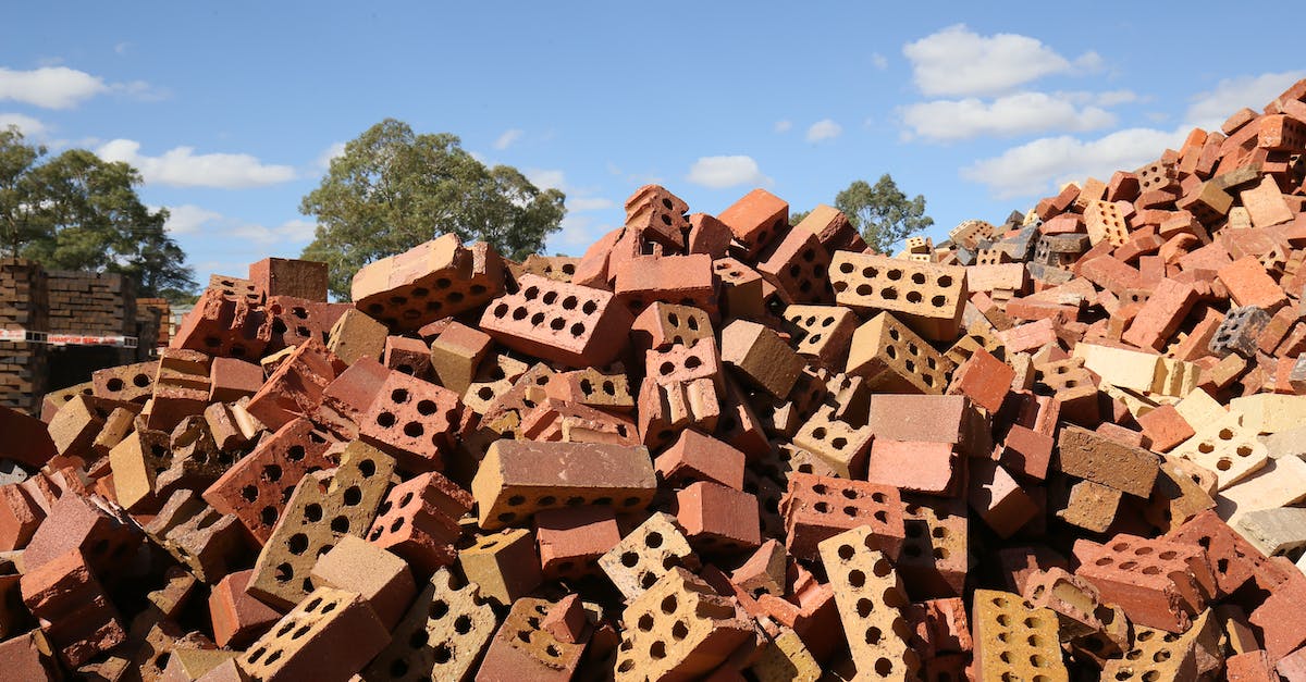 What damage does red buff deals? [duplicate] - Damaged red bricks heaped together on building yard under blue sky in daylight