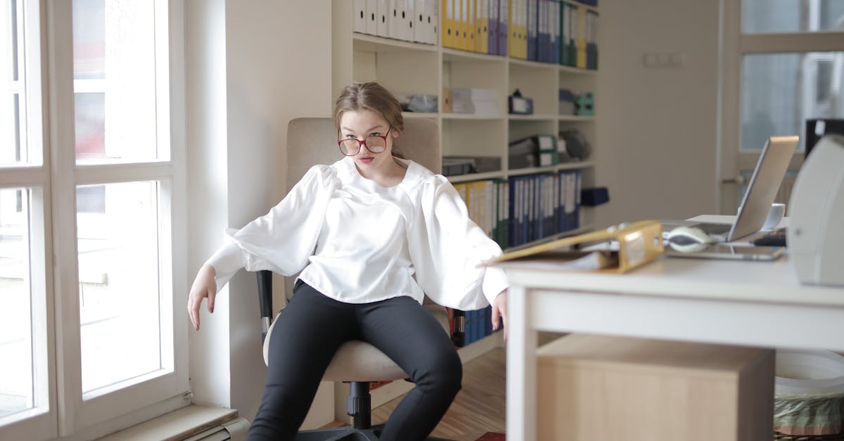 What decreases the negative exp effect on jobs - Bossy female employee in formal wear sitting on chair in workplace and demonstrating frivolous and unprofessional behavior while looking away