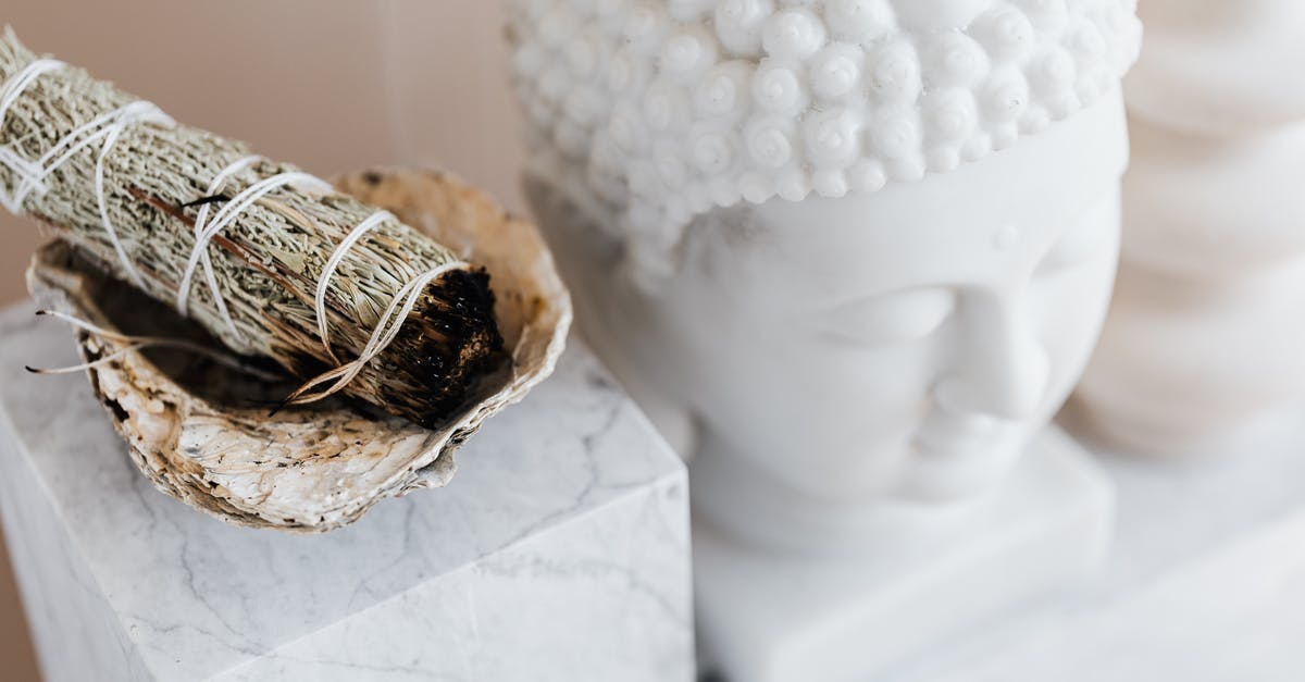 What determines how much Tribute you get from a Ritual encounter? - From above of sage candle in bowl placed on white marble shelf near plaster Buddha bust and creative shape vase for home decoration