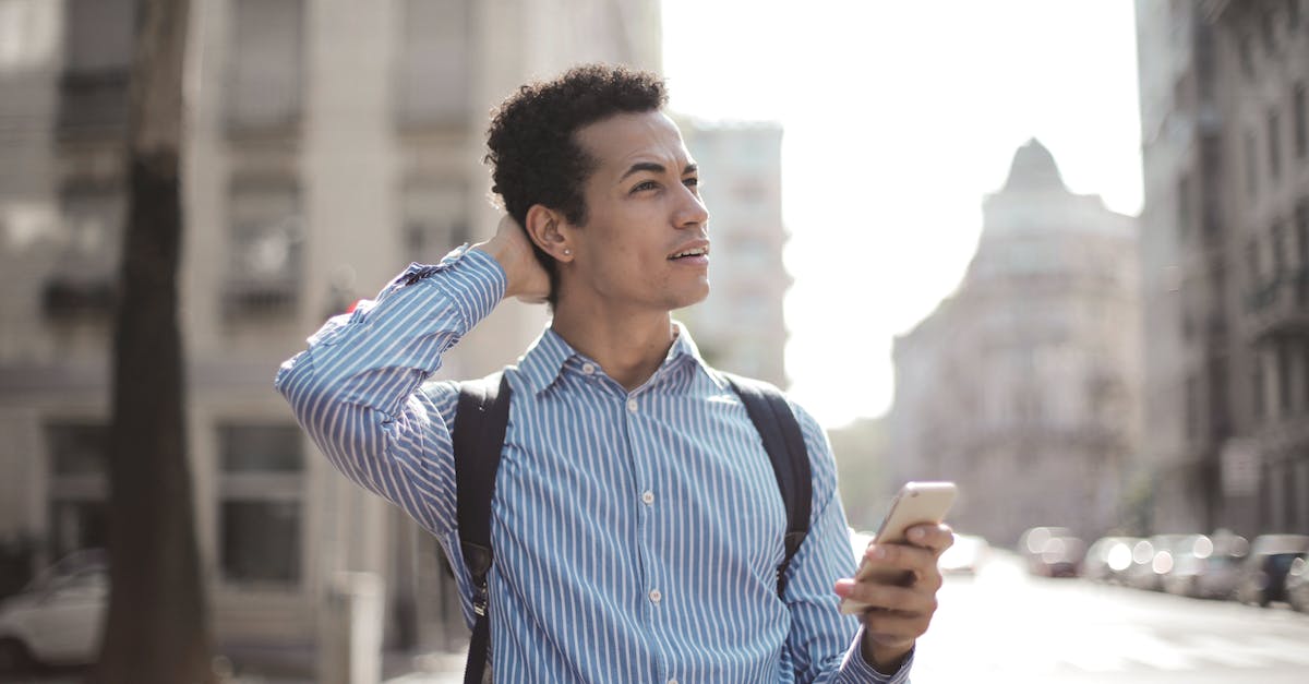 What determines if a city's population uses resource squares or becomes worker in the city? - Thoughtful man using smartphone on street What determines if a city's population uses resource squares or becomes worker in the city? - Thoughtful man using smartphone on street