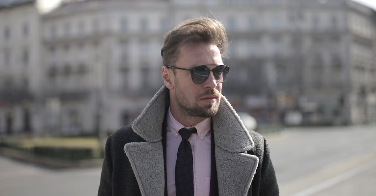 What determines if a "Street Pass" goes to your town? - Determined male in trendy sunglasses and elegant outfit standing on street during weekend stroll and looking away