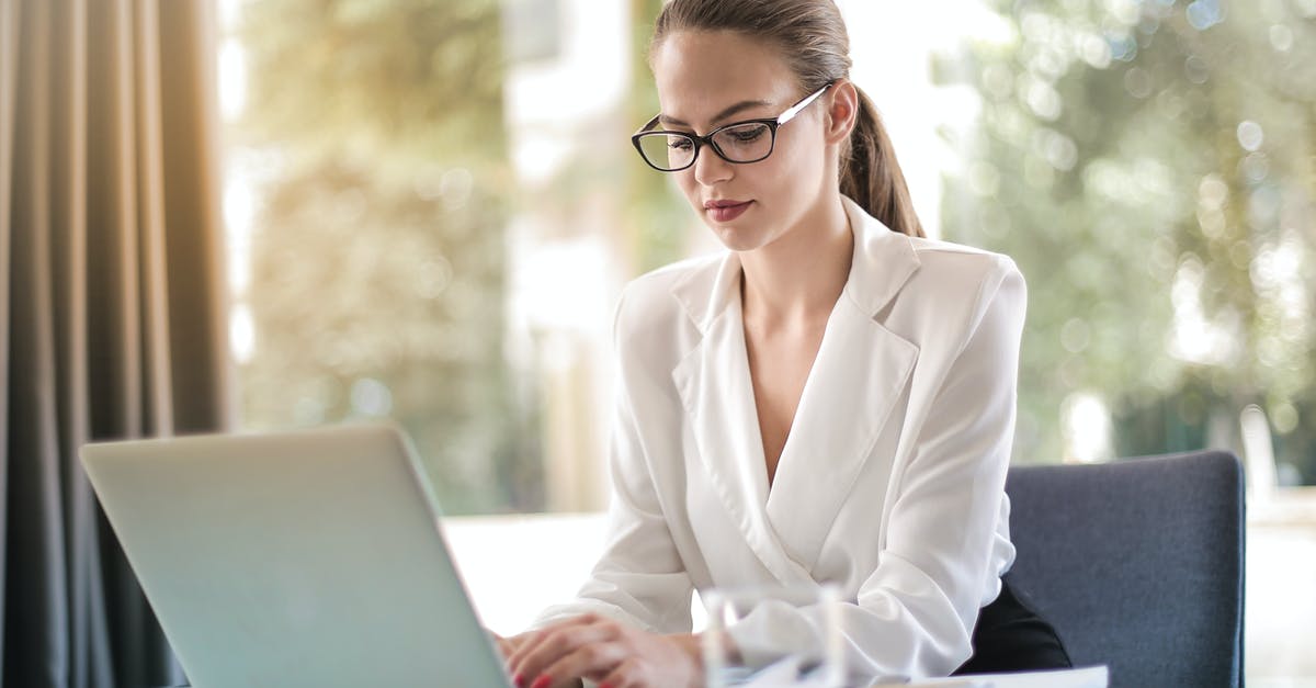What determines Technological Enlightenment rate? - Concentrated female entrepreneur typing on laptop in workplace