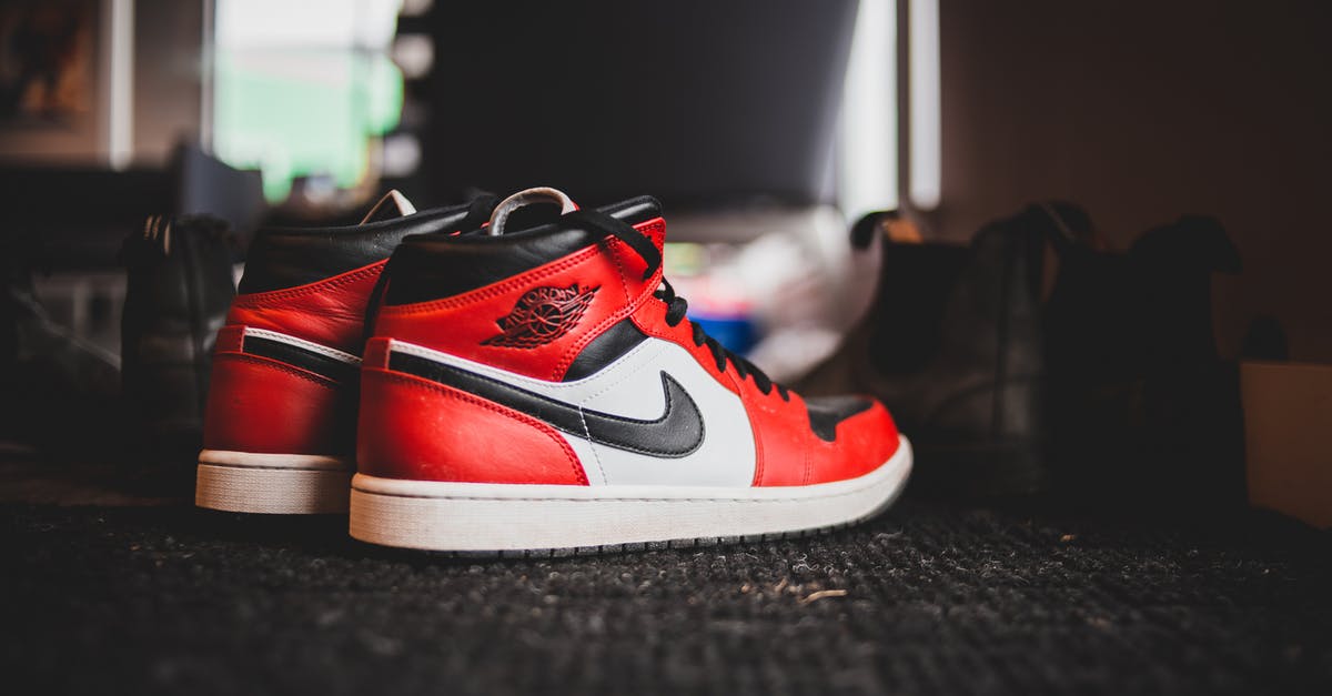 What determines the level of new heros? - Pair of stylish red sneakers placed on floor with black carpet in room in daytime What determines the level of new heros? - Pair of stylish red sneakers placed on floor with black carpet in room in daytime