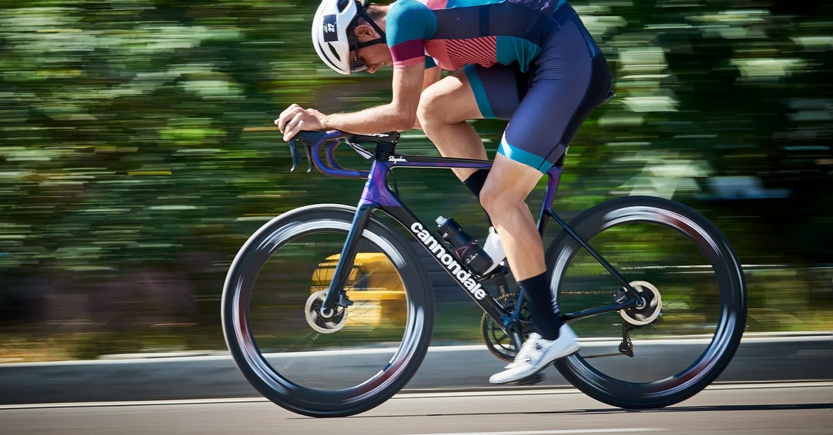 What determines track speed? - Bicyclist riding bike on asphalt road