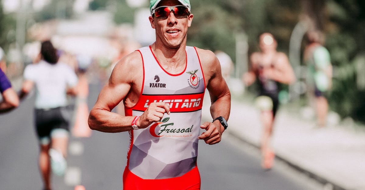 What determines track speed? - Happy sportsman running on asphalt track