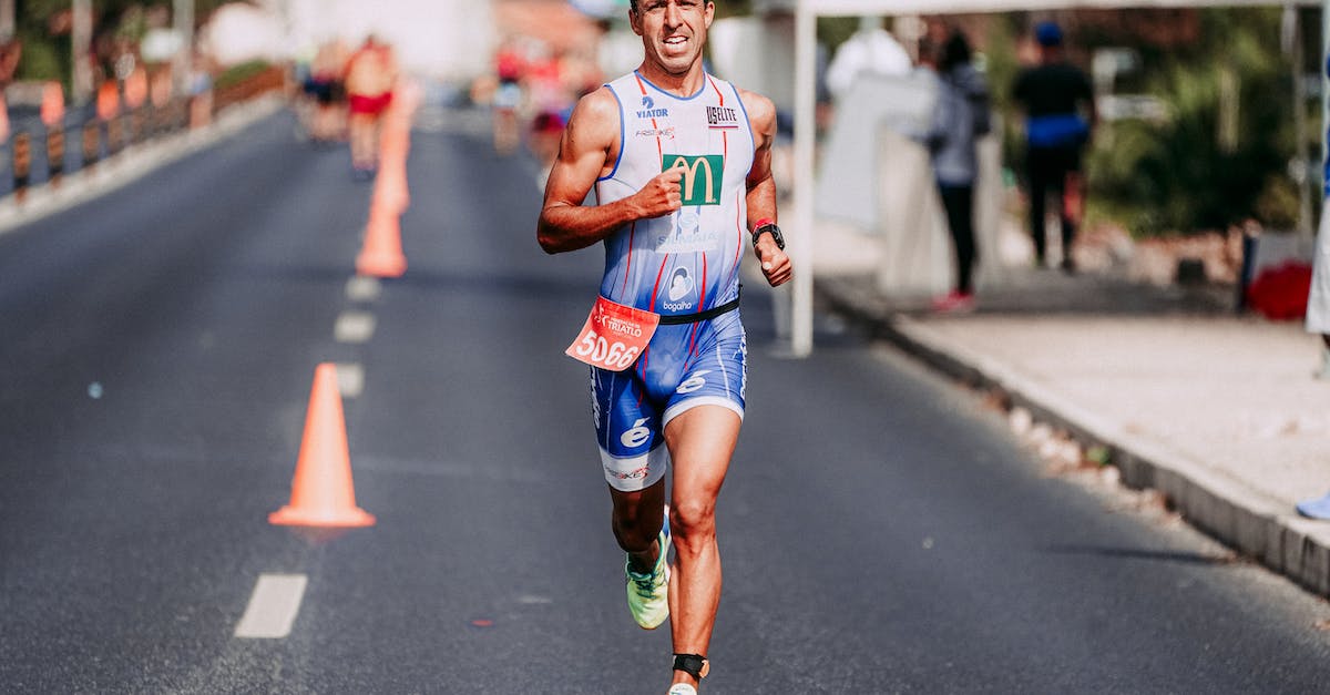 What determines track speed? - Full body of focused man in sportswear running fast on track during competition
