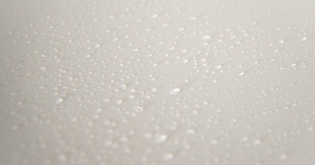 What do differently coloured slimes drop? - From above of abstract backdrop representing small pure liquid drips with transparent surface on white background What do differently coloured slimes drop? - From above of abstract backdrop representing small pure liquid drips with transparent surface on white background