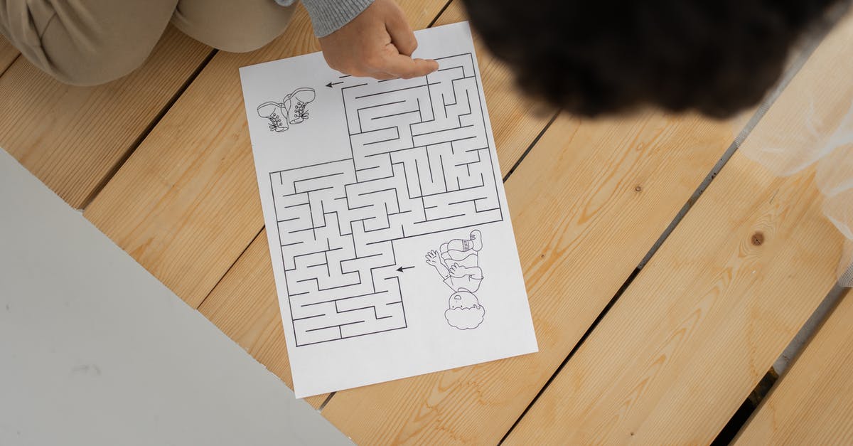 What do I do to solve the Witchess puzzles? - Unrecognizable child solving labyrinth test printed on paper at home What do I do to solve the Witchess puzzles? - Unrecognizable child solving labyrinth test printed on paper at home