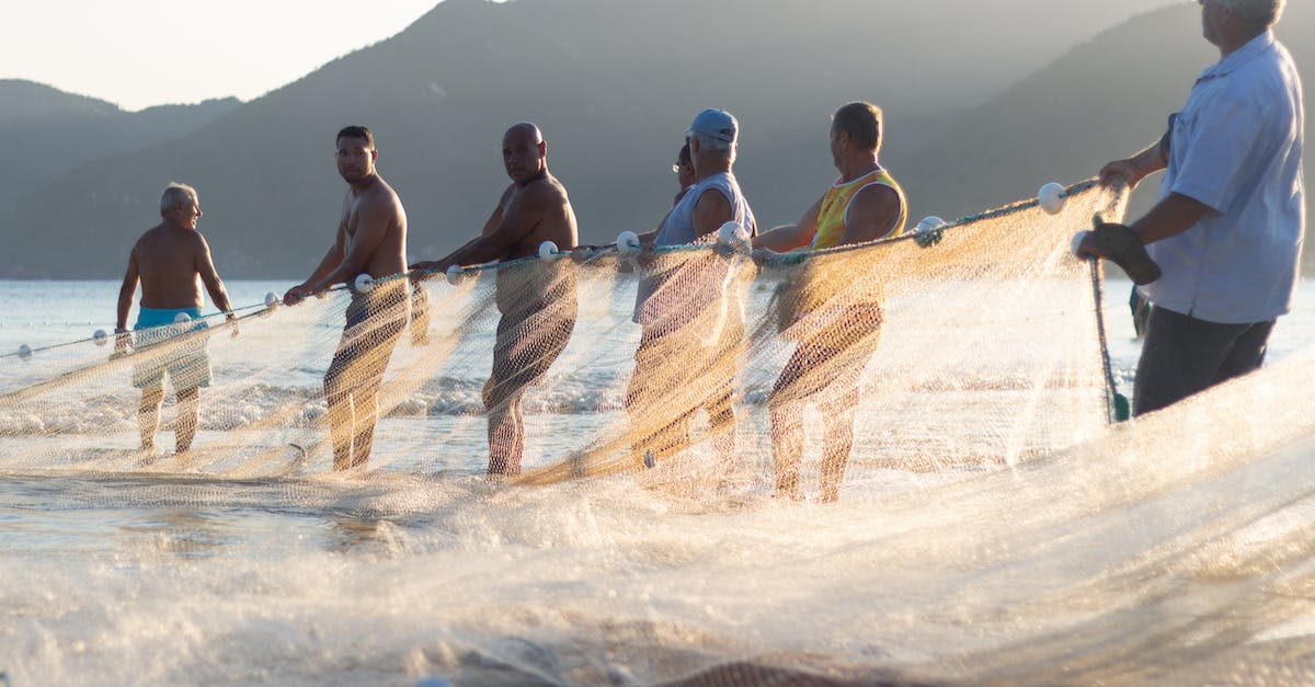 What do I do with Human cargo? - Men Holding A Fishing Net What do I do with Human cargo? - Men Holding A Fishing Net