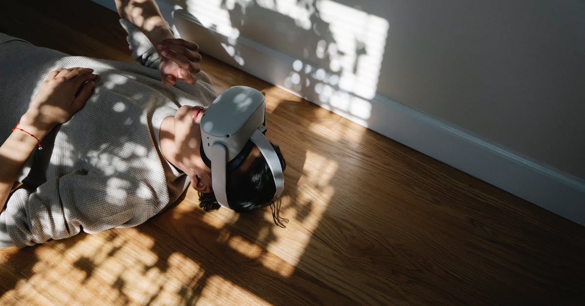 What do I get experience from? - High angle of male experiencing virtual reality in goggles while lying on floor in sunbeams at home What do I get experience from? - High angle of male experiencing virtual reality in goggles while lying on floor in sunbeams at home