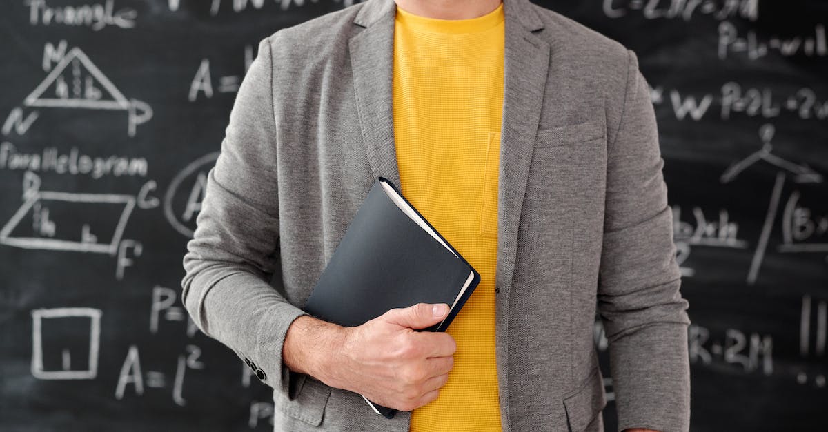 What do I get out of this equation and how? - Man in Gray Blazer Holding Black Book