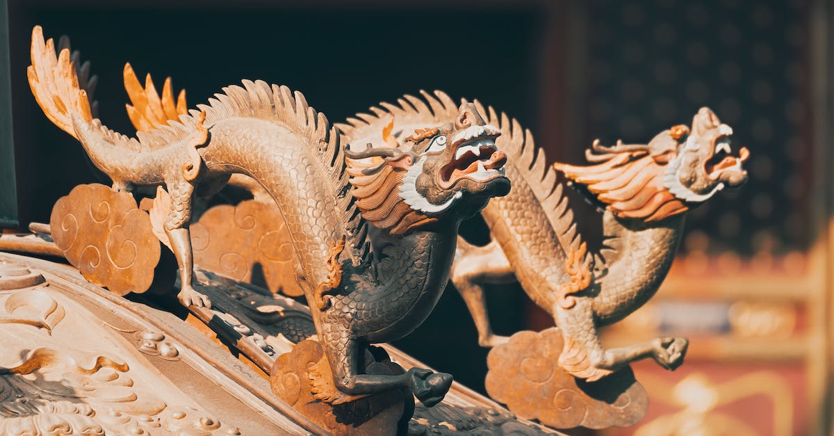 What do spheres above dragons mean? - Gold Dragon Figurine on Black Table