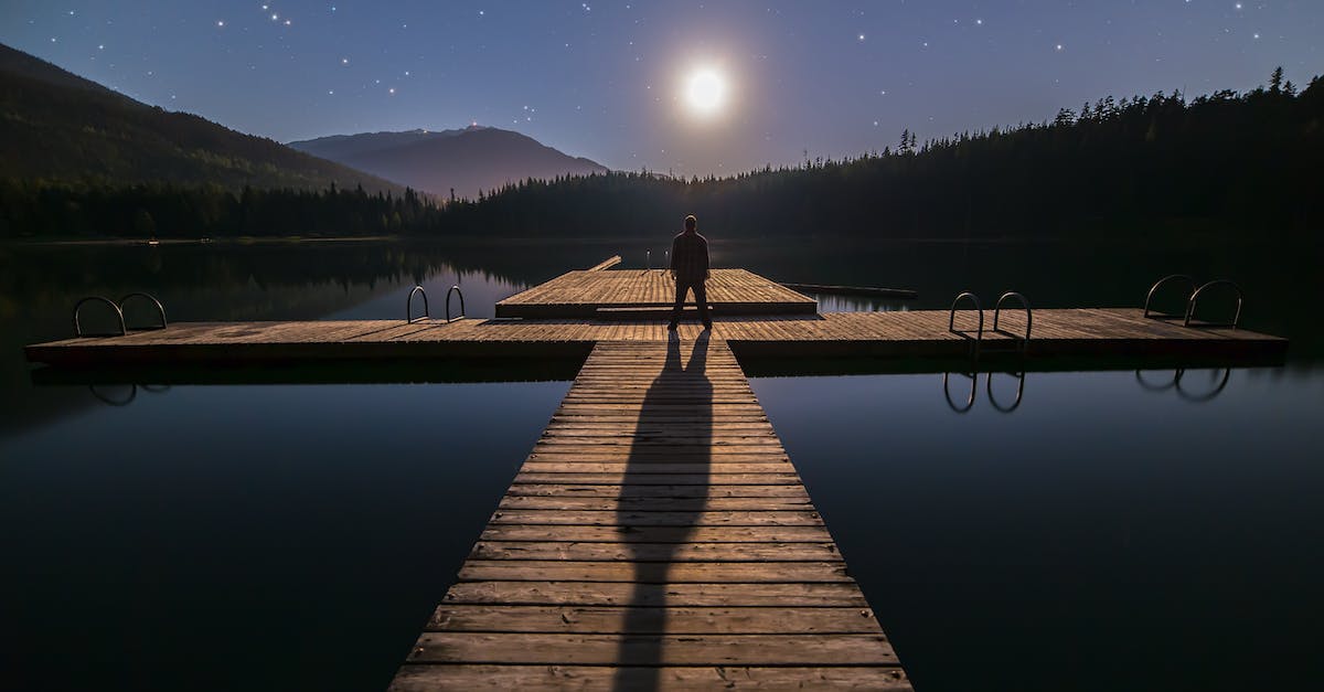 What do the blue stars on areas mean? - Silhouette of Person Standing on Bridge