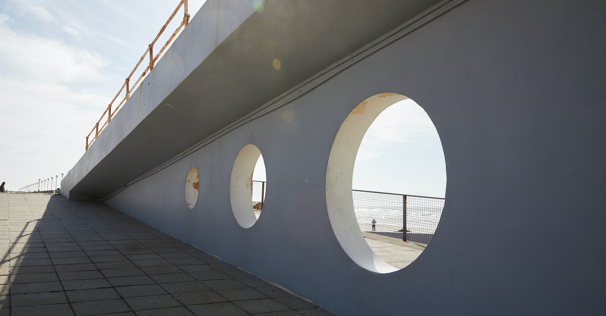 What do the circle of stones represent? - Holes in wall of bridge in daytime What do the circle of stones represent? - Holes in wall of bridge in daytime