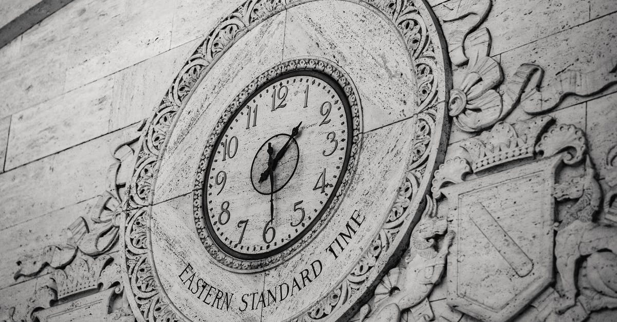 What do the circle of stones represent? - From below black and white of stone wall with ornamental details around clock showing Eastern Standard Time What do the circle of stones represent? - From below black and white of stone wall with ornamental details around clock showing Eastern Standard Time