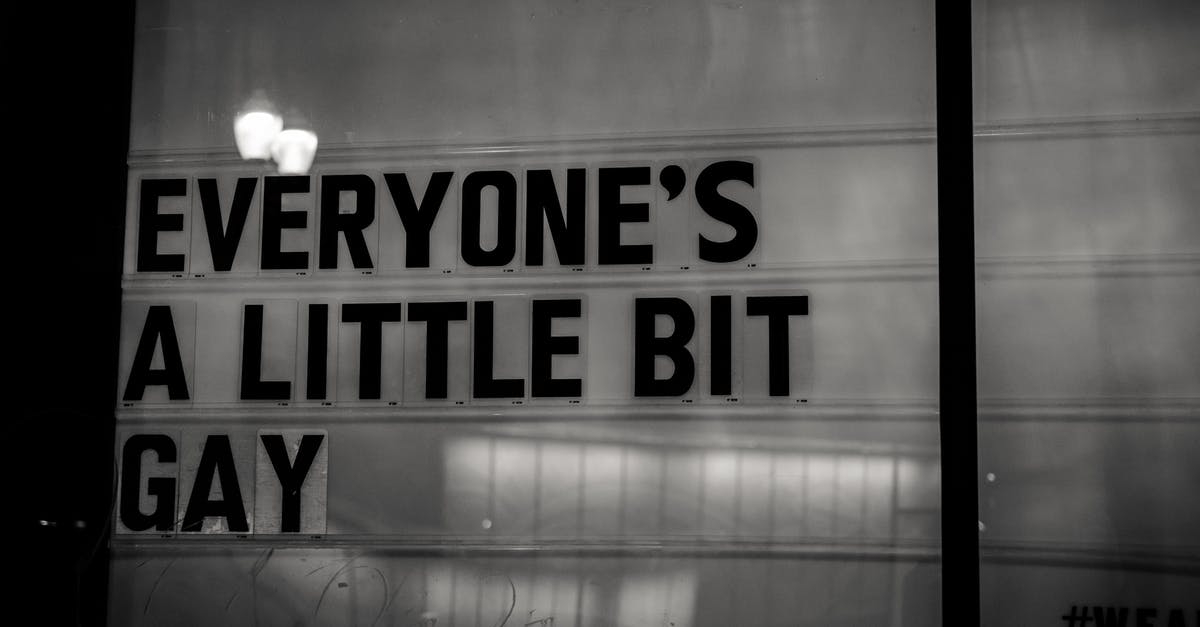 What do the colors of the light shining from the Gacha door mean? - signage on glass