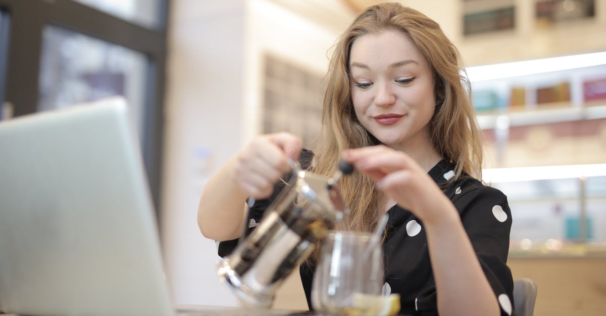 What do the dots next to the fps counter mean? - Relaxed female in trendy polka dot dress pouring hot beverage from french press into glass mug while chilling in cafe during weekend
