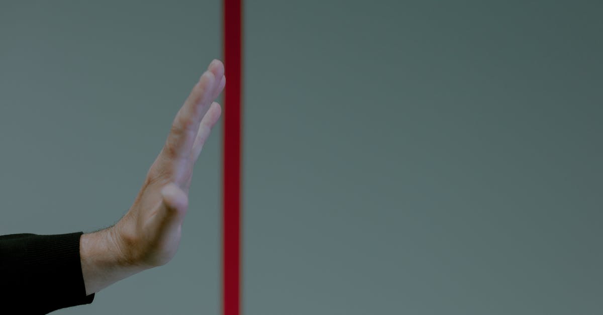 What do the exclamation marks with red borders mean on the Boston map? - Studio shot of hand behind red line What do the exclamation marks with red borders mean on the Boston map? - Studio shot of hand behind red line