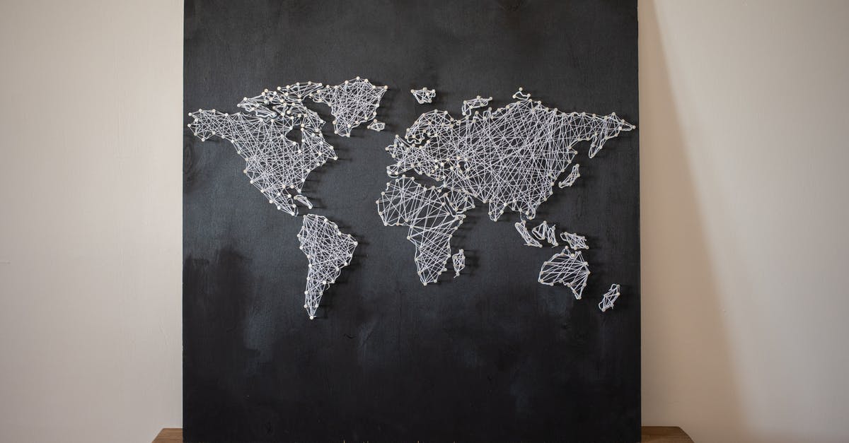 What do these strings below the map names mean? - Decorative creative world continents made of threads on black board placed on wooden shelf on white background in light room