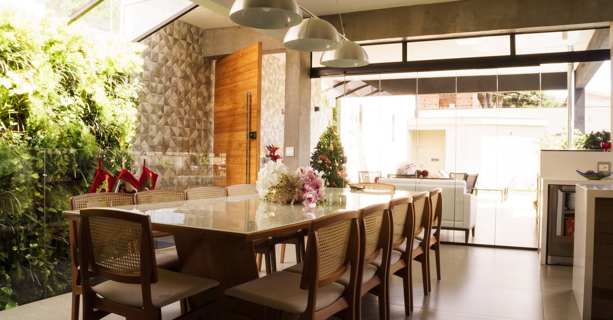 What do you get for mining the new Christmas tree? - Interior of cozy spacious kitchen with glass table and comfortable seats decorated for Christmas celebration with small tree illumination and stockings What do you get for mining the new Christmas tree? - Interior of cozy spacious kitchen with glass table and comfortable seats decorated for Christmas celebration with small tree illumination and stockings