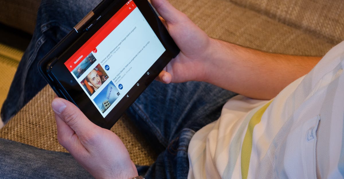 What does a Valve Anti-Cheat (VAC) notification look like? - Person Holding Tablet Computer Showing Videos