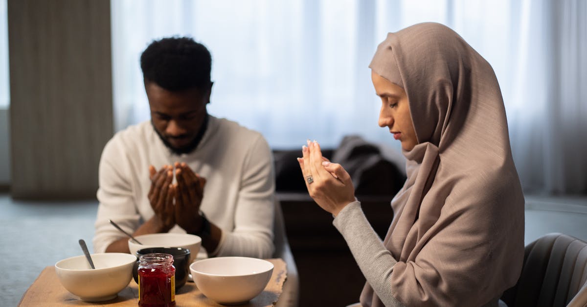 What does buying a wish in Sega's Aladdin do? - Multiethnic couple praying at table before eating What does buying a wish in Sega's Aladdin do? - Multiethnic couple praying at table before eating