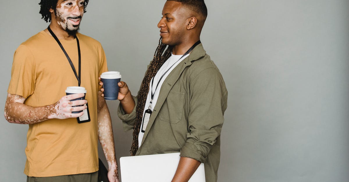 What does F.A.N.G.'s name stand for? - Black friends in casual clothes with name tags standing with cups of takeaway coffee on coffee break against gray wall What does F.A.N.G.'s name stand for? - Black friends in casual clothes with name tags standing with cups of takeaway coffee on coffee break against gray wall