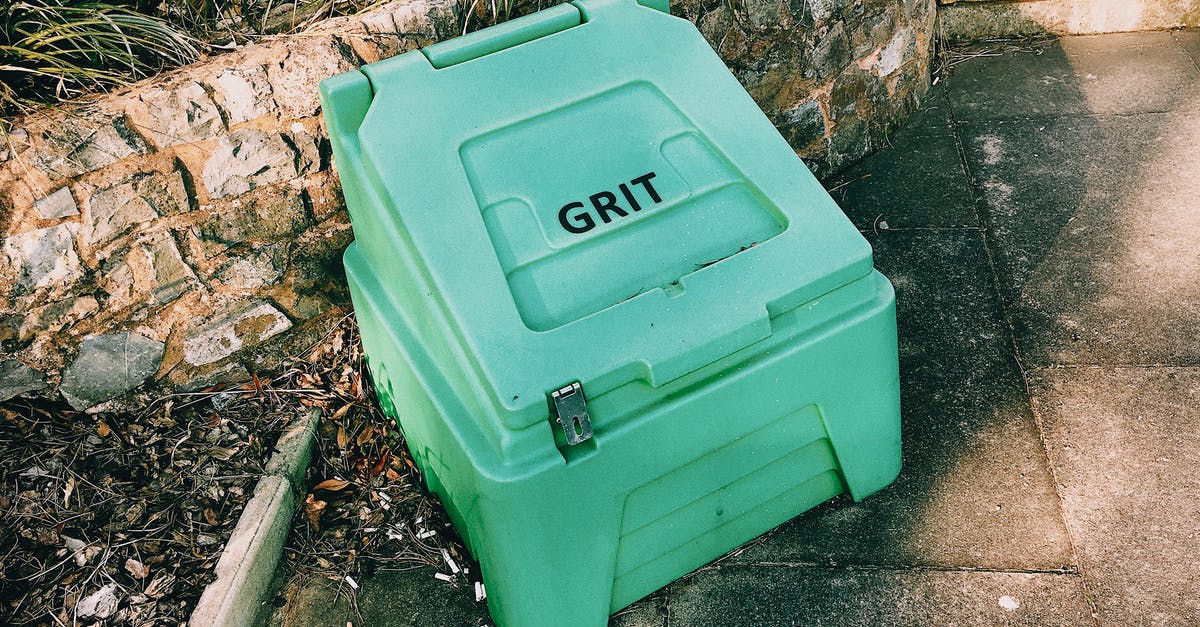 What does Grit do in Renowned Explorers? - Container near stone barrier on street