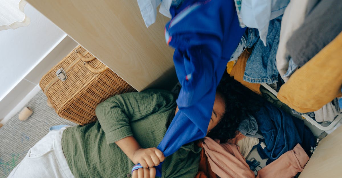 What does it mean if you have a hanger on your profile pic? - Anonymous black girl lying on stack of clothes in bedroom