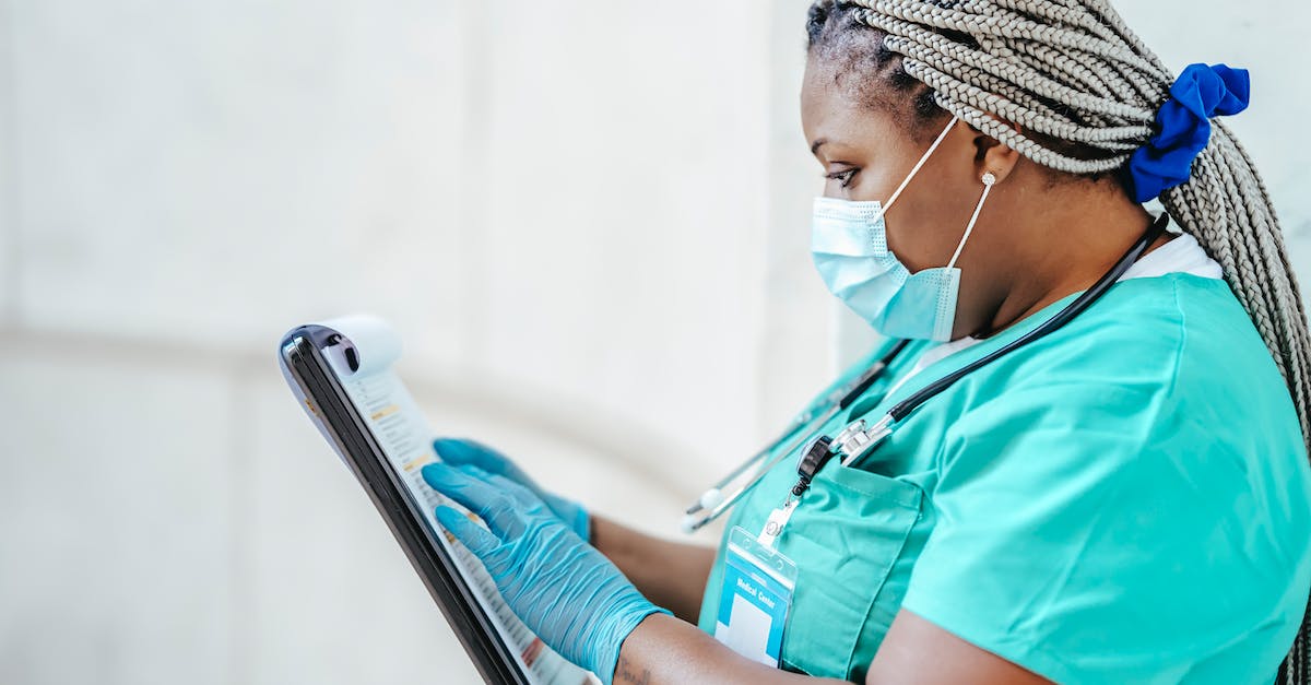 What does selecting a badge in the profile view in the scanner do? - Black physician reading document on clipboard at work What does selecting a badge in the profile view in the scanner do? - Black physician reading document on clipboard at work