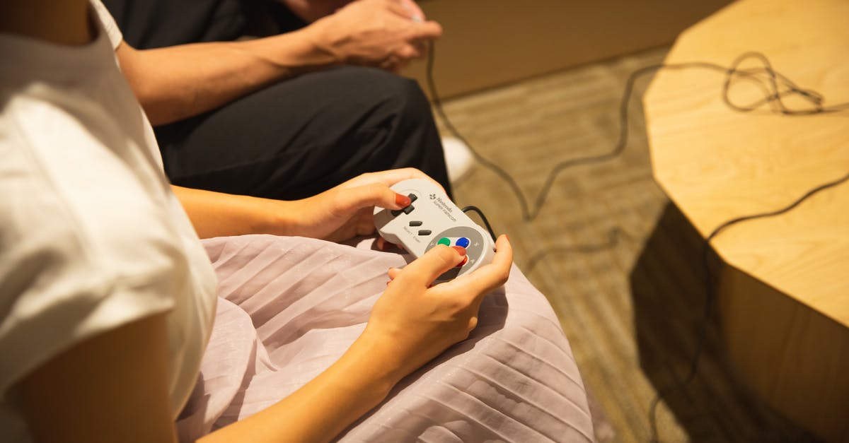 What does the 'Play in Starships' button do? - Unrecognizable couple playing video game with gamepads at home What does the 'Play in Starships' button do? - Unrecognizable couple playing video game with gamepads at home