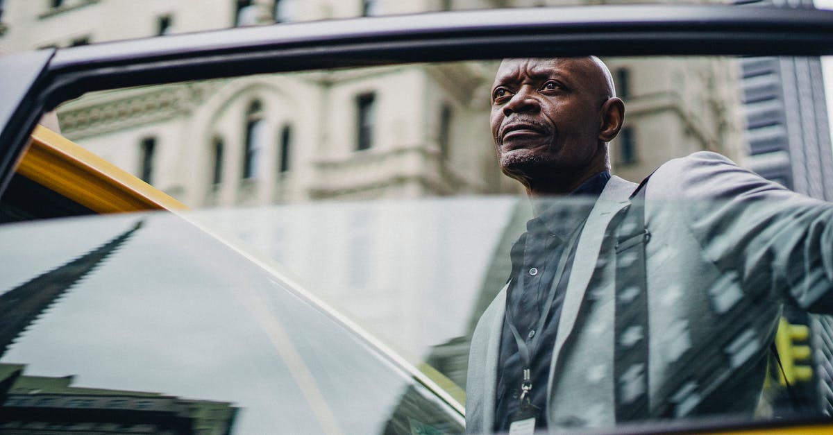 What does the door want from me? - Pondering black man opening taxi door