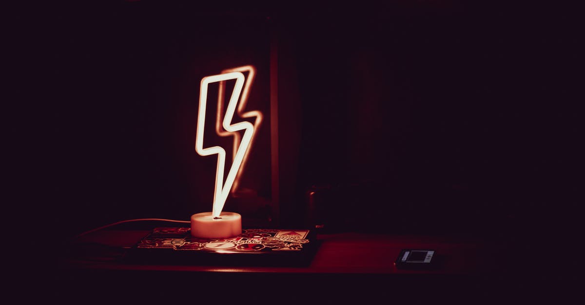 What does the lightning symbol mean? - Glowing neon lamp in shape of lightning in dark room
